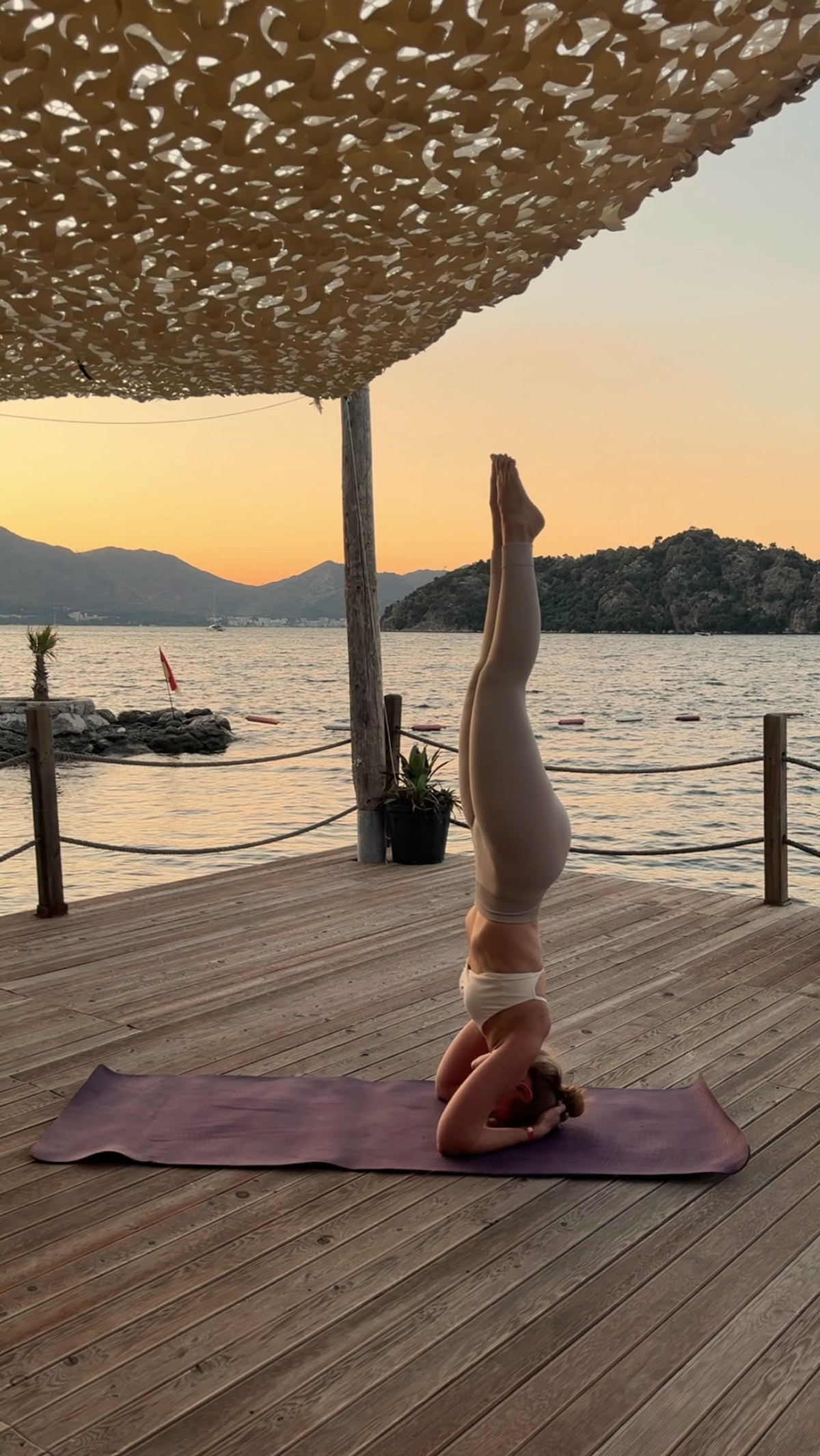 Anastasiia im Kopfstand am Meer